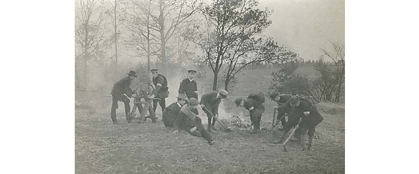 Soldiers and civilians digging a hole