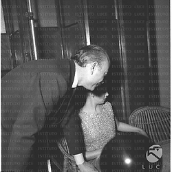 Anna Maria Pierangeli seduta  e Armando Trovajoli  di spalle durante il ricevimento- piano medio