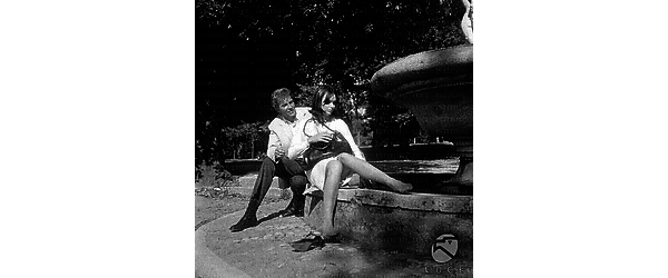 Rik Van Nutter e Barbara Steele seduti sul bordo di una fontana a Villa Borghese; la Steele è senza scarpe e sembra sul punto di bagnarsi i piedi - totale