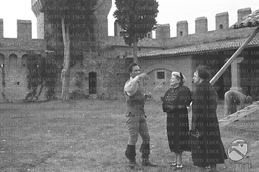 Castello di Gradara Luis Trenker, in abiti di scena, illustra il set del film "Condottieri" a Rachele Mussolini e ad altre donne
