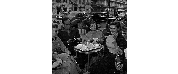 Rossana Podestà seduta ad un bar in via Veneto con altri colleghi