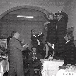 Diego Calcagno balla su un tavolo con Alba Arnova, tra i presenti Gorni Kramer