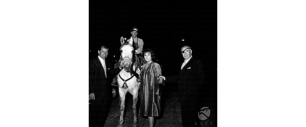 Roma Richard Egan con Daniela Rocca e Raul Walsh di sera davanti al ristorante Meo Patacca accanto ad un uomo a cavallo in costume tradizionale
