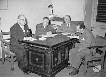 Roma Gonella, Romita, Villabruna e Reale sono seduti ad una scrivania a palazzo Wedekind in occasione di una riunione quadripartito
