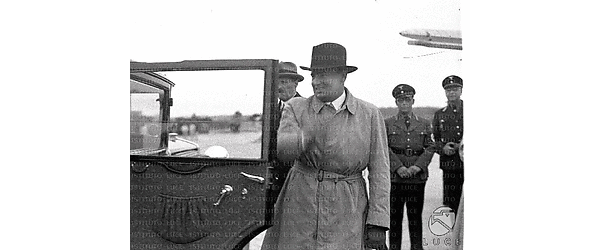 Roma Hans Frank colto vicino ad un'automobile sulla pista dell'aeroporto; alle sue spalle si riconosce l'ambasciatore tedesco Ulrich von Hassell