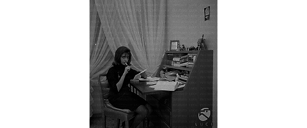 Ludovica Modugno seduta ad uno scrittoio; piano americano