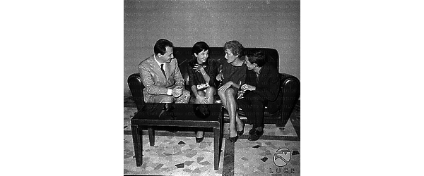 Enzo Battaglia chiacchiera su un divanetto con alcuni degli interpreti del suo film 'Gli arcangeli'