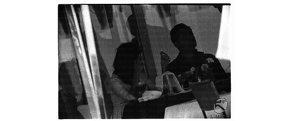 Michael Todd ed Elizabeth Taylor seduti in un bar - piano medio