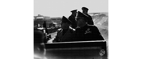 Roma Il Duce, seduto a fianco di Armando Brasini sulla vettura di un trenino, visita uno dei cantieri delle grandi opere in costruzione