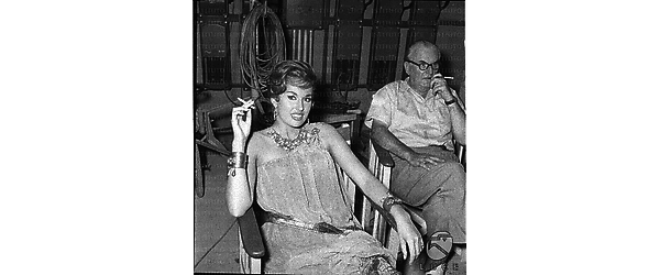 L'attrice Sylvia Lopez, negli studi di Cinecittà, in una pausa della lavorazione del film "Erode il grande" seduta accanto al regista Arnaldo Genoino - piano americano
