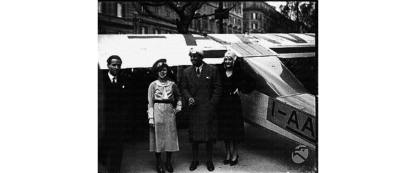 Roma L'attore Douglas Fairbanks colto in tenuta da aviatore in compagnia di due signore accanto a un aereo parcheggiato in via Veneto